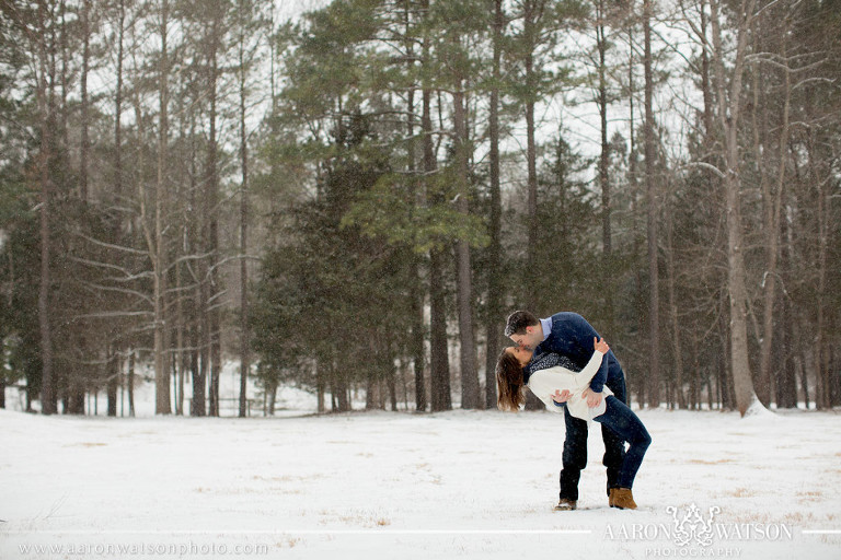 couple dipping in a snowy field 